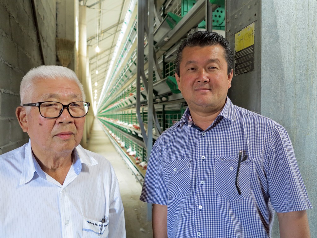 近代的な成鶏舎の中で伊藤悟さんと秀樹さん