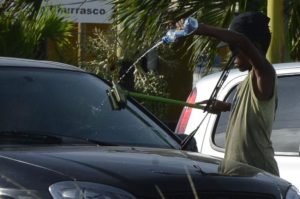 信号待ちの車に駆け寄り、「窓ガラスを拭くからお金を頂戴」とせがむ少年（参考画像・Valter Campanato/Agência Brasil）