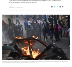 国家警備隊のビデオに応答し、軍兵士らの接近を阻止するために車に火を放つなどの抗議行動を行ったベネズエラの人々（２１日付Ｇ１サイトの記事の一部）