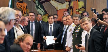 ボルソナロ大統領（中央左）と、受け取ったばかりの軍関係者年金改革法案を見せるロドリゴ・マイア議長（J.Batista / Camara dos Deptados）